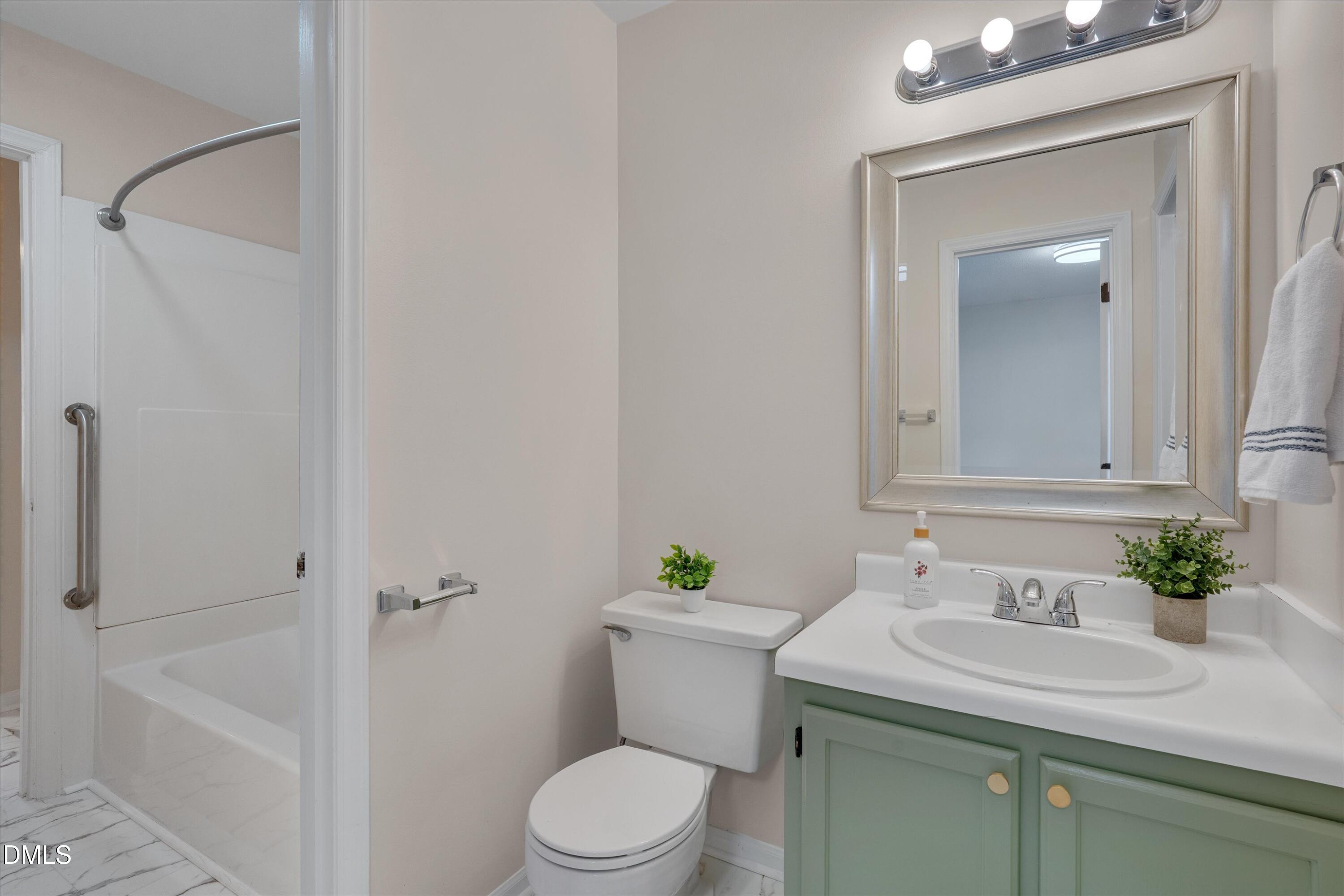 6528 Hearthstone Drive Raleigh, NC 27615 - Photo 23 of 32 a bathroom with a sink a toilet and shower