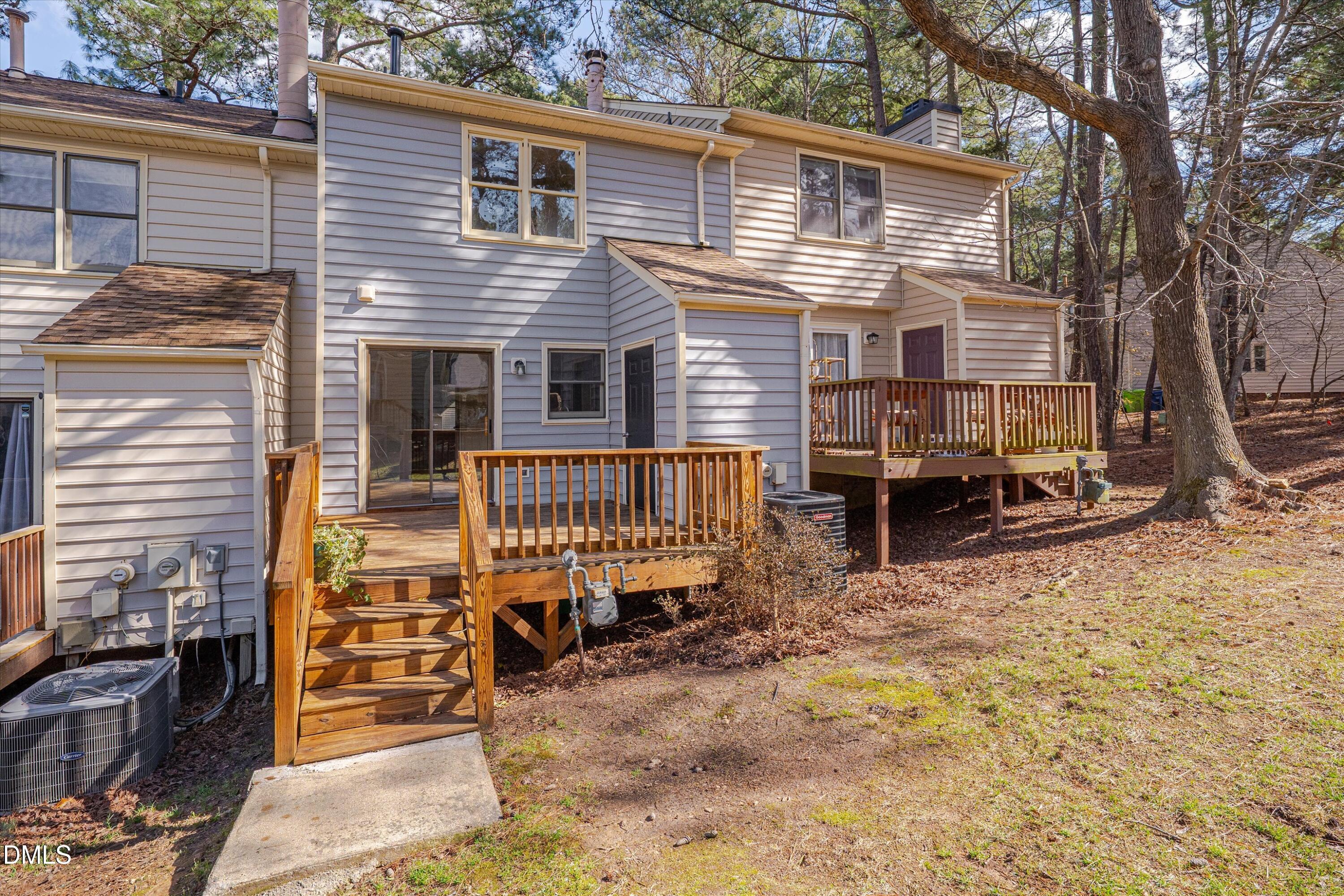 6528 Hearthstone Drive Raleigh, NC 27615 - Photo 29 of 32 a view of a house with a yard chairs and wooden fence