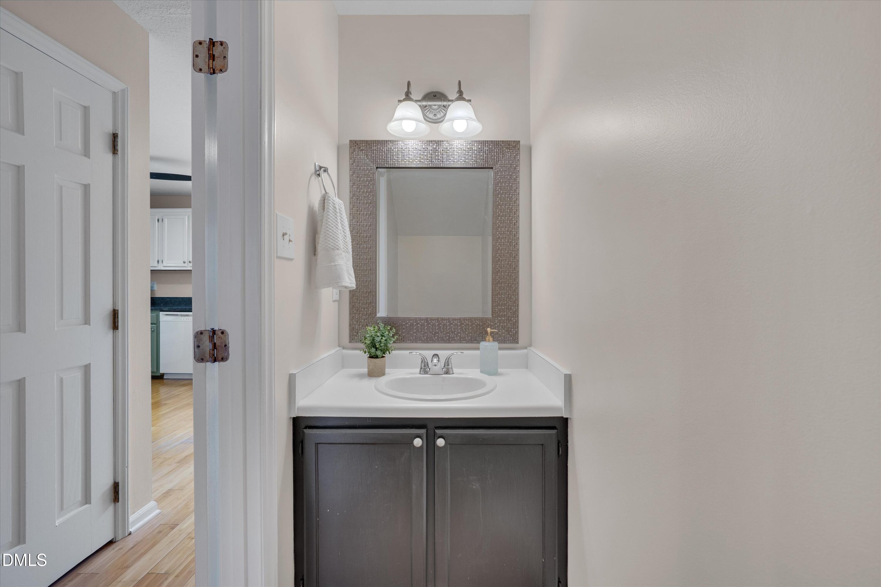 6528 Hearthstone Drive Raleigh, NC 27615 - Photo 9 of 32 a bathroom with a sink and a mirror