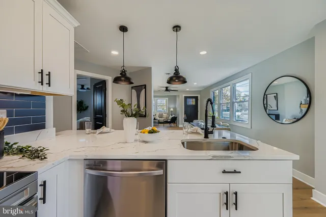 a kitchen with a sink a counter space and stainless steel appliances