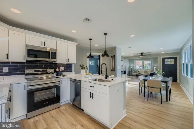 a kitchen with a sink stove and cabinets