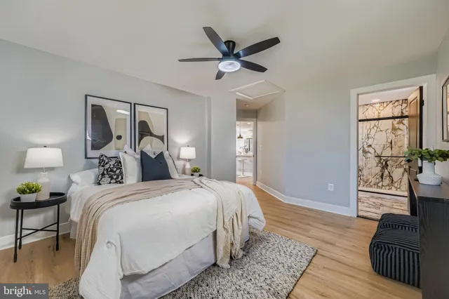 a bedroom with a bed and wooden floor