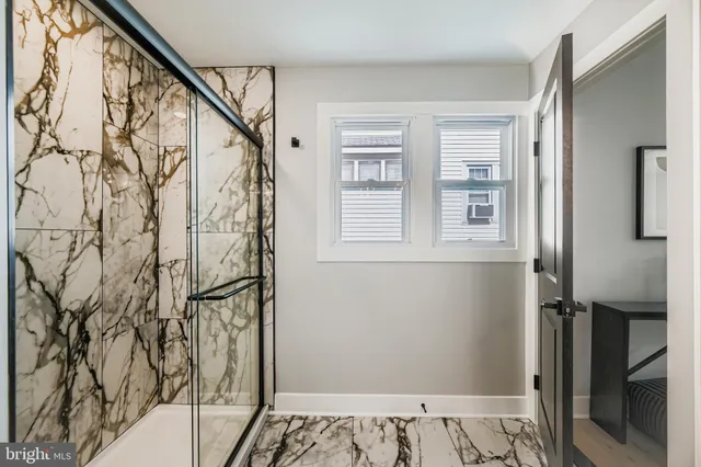 a bathroom with a bathtub and shower
