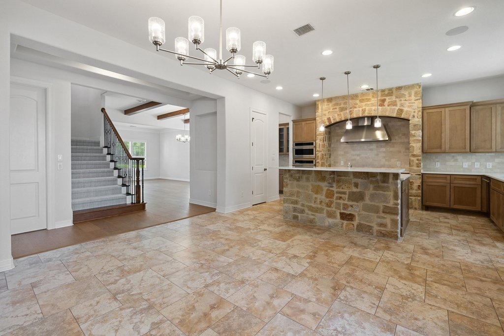 109 Largo Cove Austin, TX 78734 - Photo 11 of 40 A well-appointed kitchen showcases stone accents and modern appliances, creating a welcoming atmosphere.