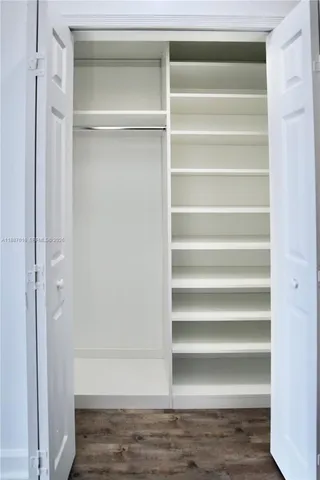 a view of walk in closet with empty racks