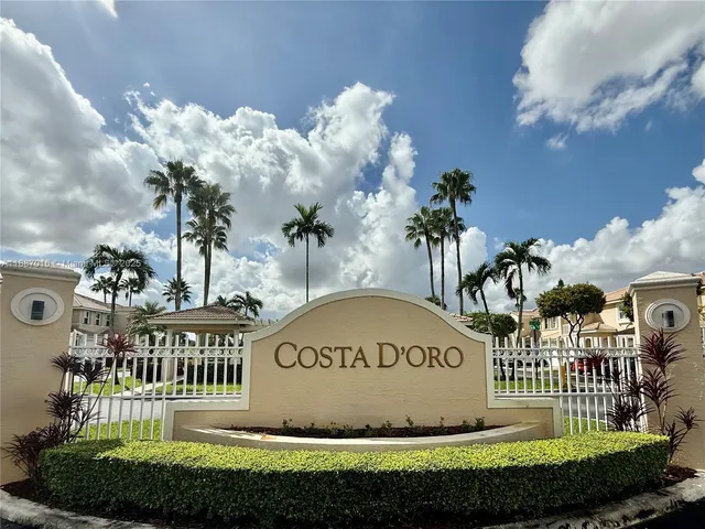 a view of a garden with lawn chairs and a fire pit