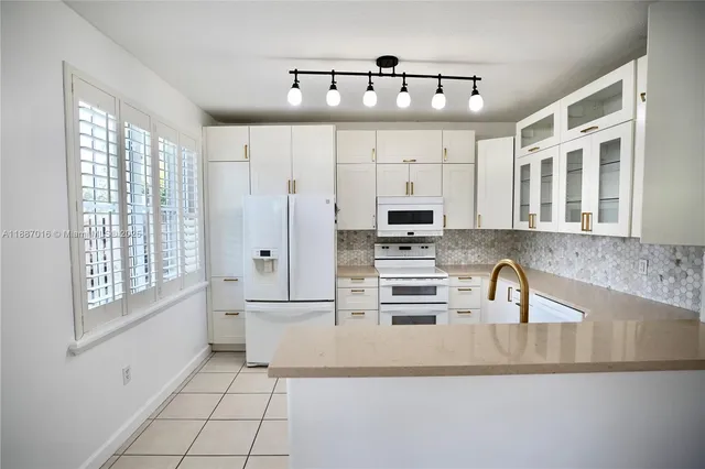 a kitchen with stainless steel appliances a sink and cabinets