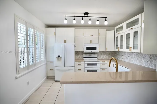 a kitchen with stainless steel appliances a sink and cabinets