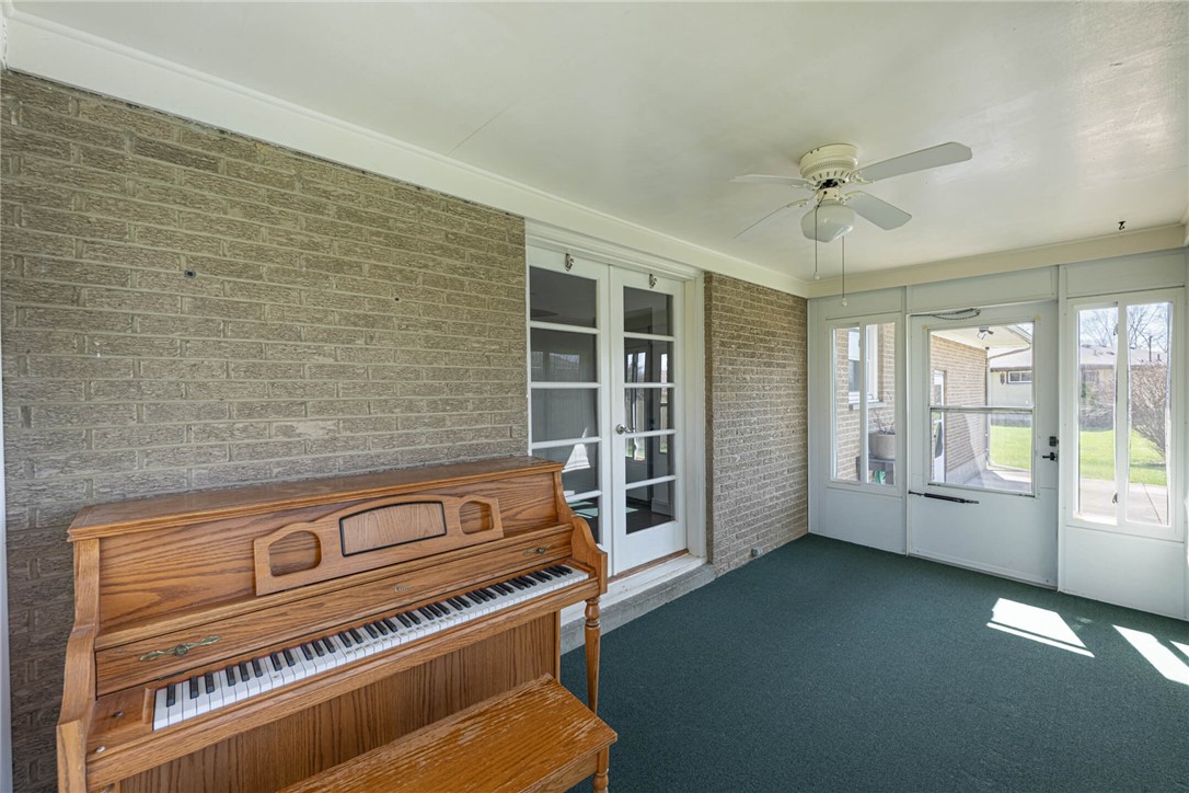 5235 West Ridgewood Road Springfield, OH 45503 - Photo 28 of 32 This bright sunroom offers an inviting space for relaxation or entertainment, featuring ample natural light.