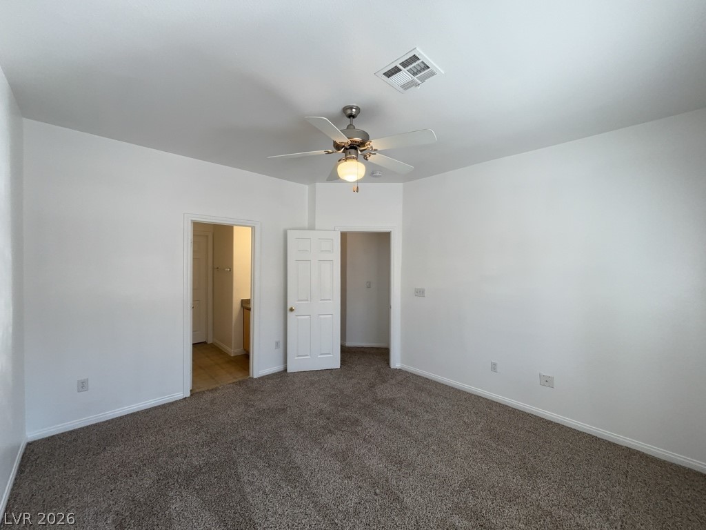 4915 East Russell Road, Unit 142 Las Vegas, NV 89120 - Photo 6 of 10 Comfortable carpeting and a ceiling fan create a pleasant living area.