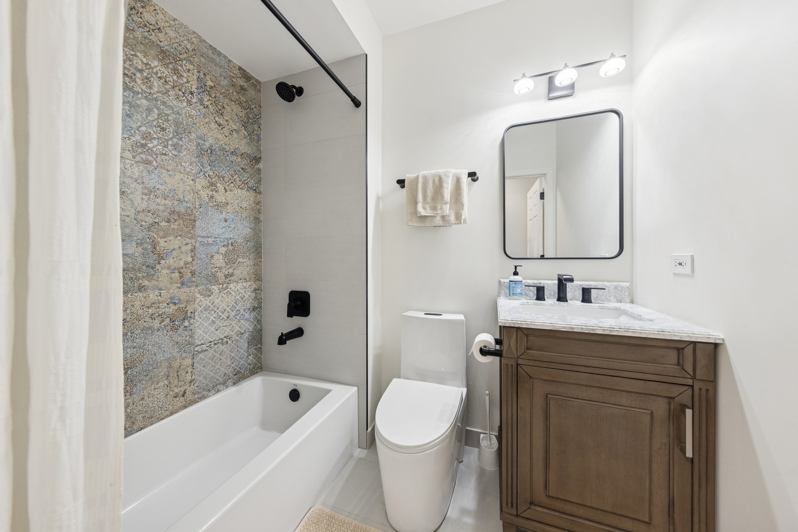 943 Elderberry Circle, Unit 303 Naperville, IL 60563 - Photo 11 of 19 a bathroom with a sink a toilet and shower