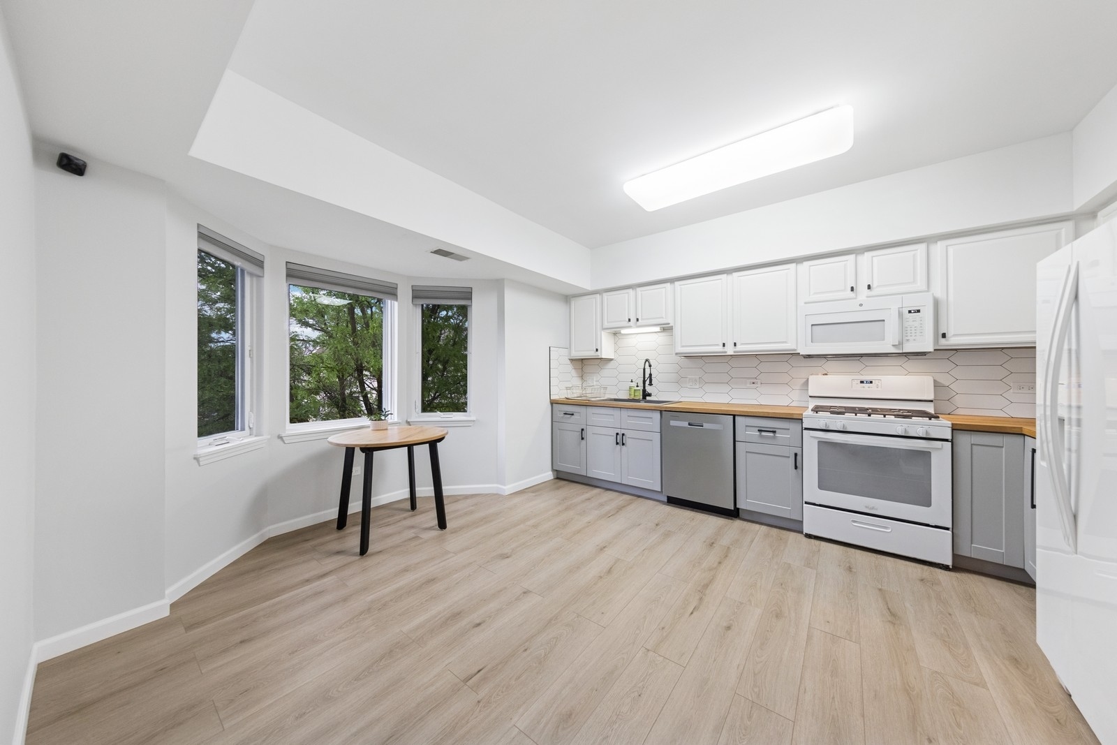 943 Elderberry Circle, Unit 303 Naperville, IL 60563 - Photo 7 of 19 a kitchen with a white stove top oven and cabinets