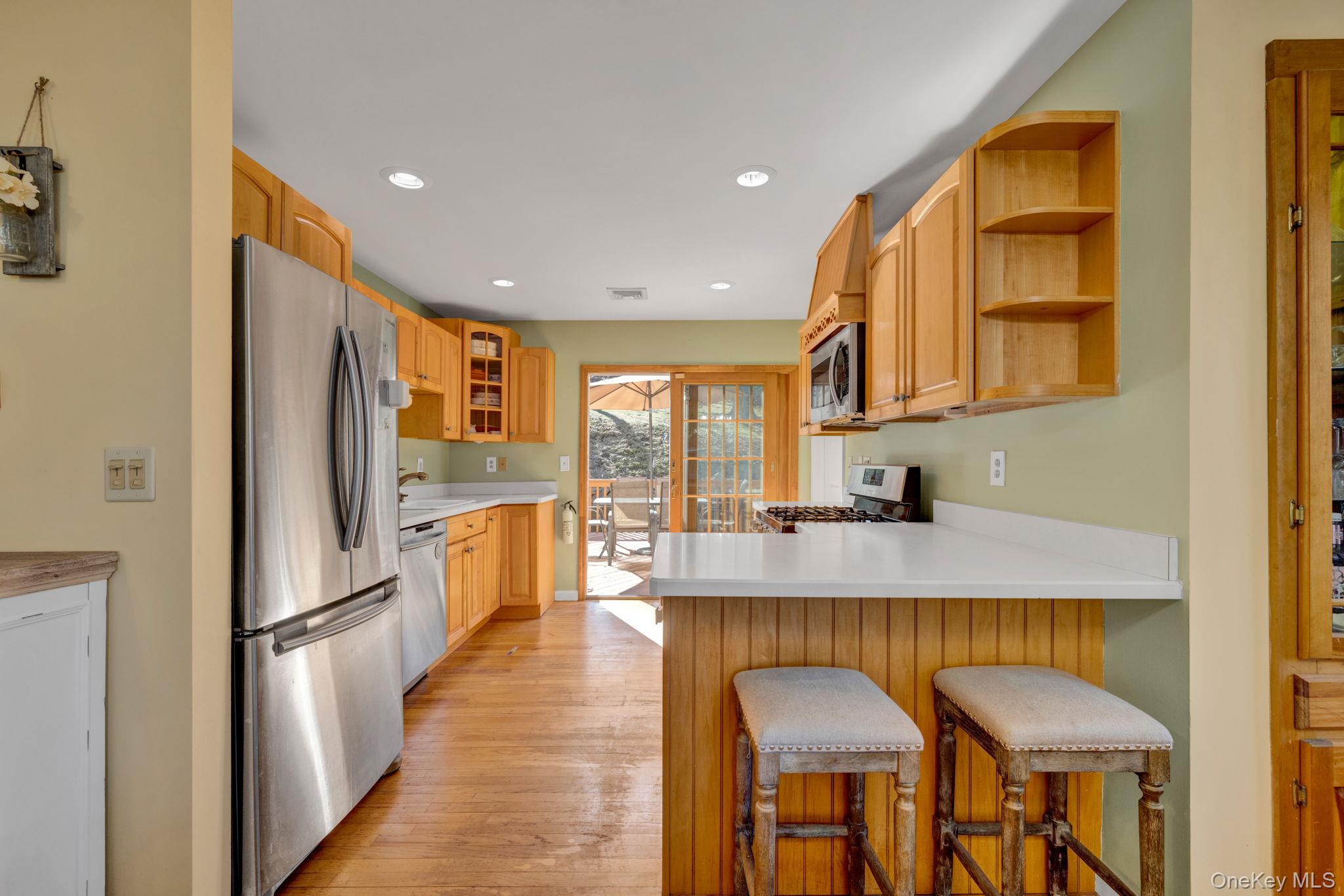 65 Jay Street Stony Point, NY 10980 - Photo 14 of 32 a kitchen with granite countertop refrigerator and wooden cabinets