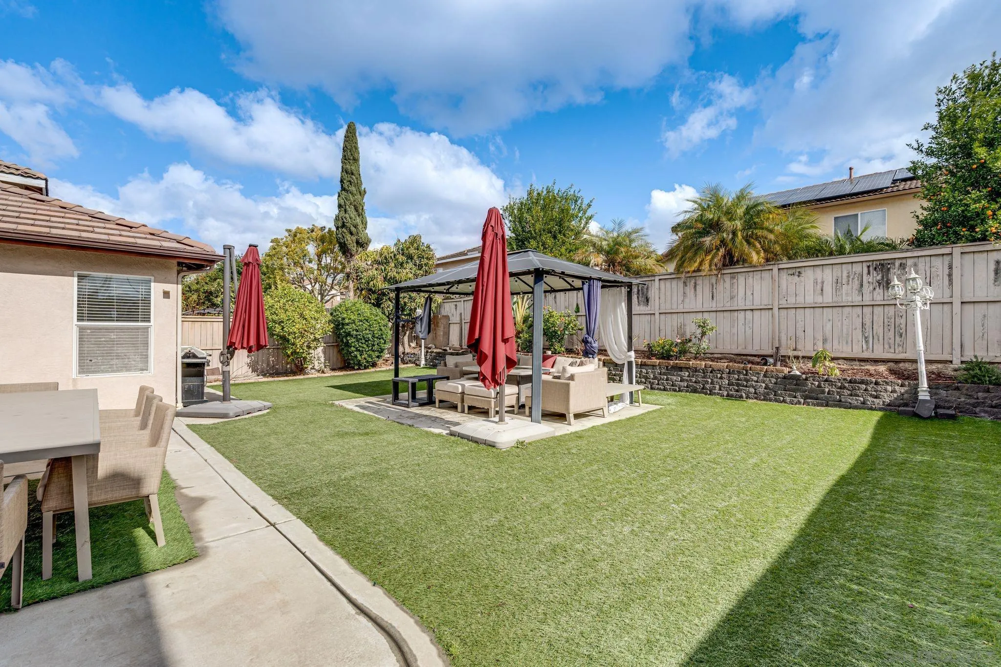 1616 Gold Run Road Chula Vista, CA 91913 - Photo 18 of 35 a view of a backyard with table and chairs and potted plants