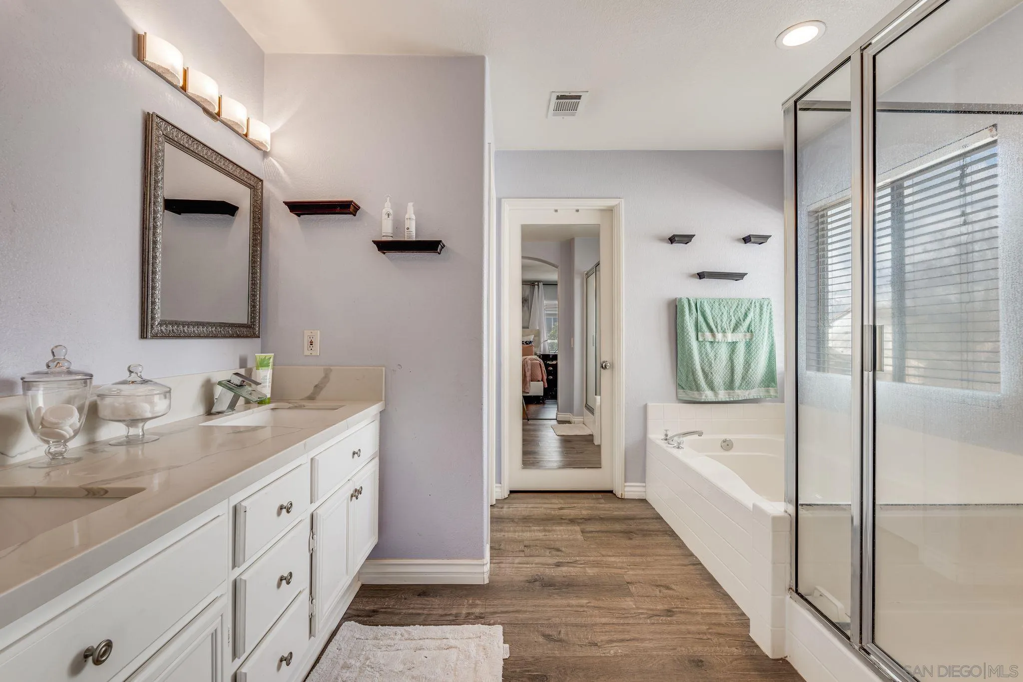 1616 Gold Run Road Chula Vista, CA 91913 - Photo 24 of 35 a spacious bathroom with double vanity a mirror and a shower