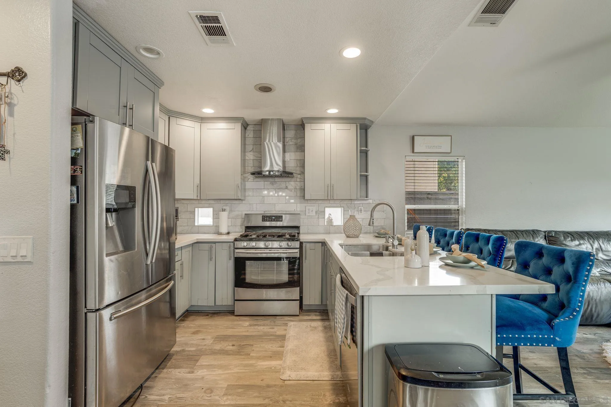 1616 Gold Run Road Chula Vista, CA 91913 - Photo 7 of 35 a kitchen with stainless steel appliances a sink stove refrigerator and cabinets