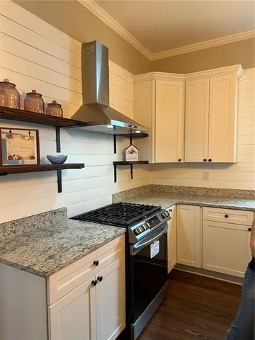 a kitchen with granite countertop cabinets sink and white appliances