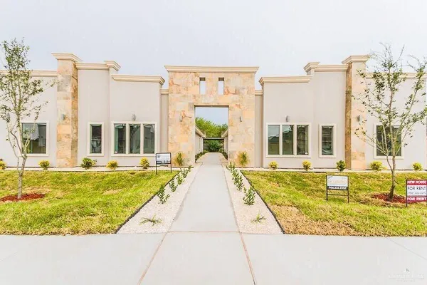 a front view of a house with a garden