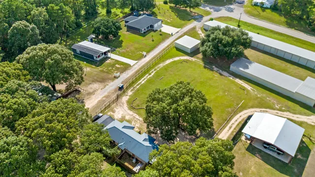 a view of swimming pool with lawn chairs under an umbrella