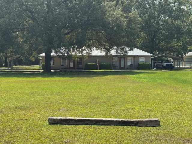 a view of a swimming pool and trees in the background