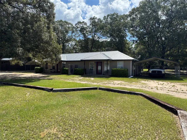 a view of swimming pool with lawn chair under an umbrella