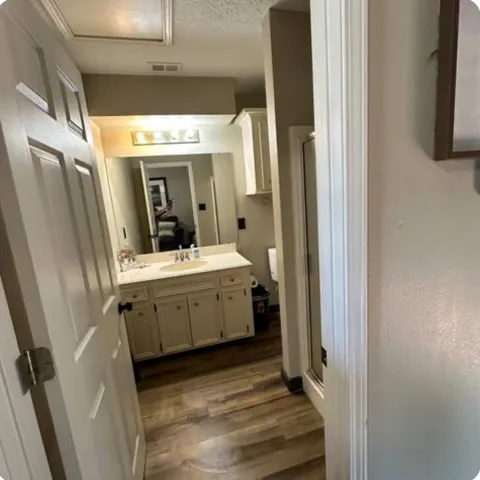 a bathroom with a sink a mirror and a shower