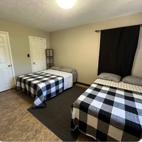 a bedroom with bed and window