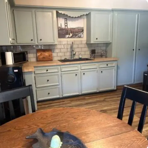 a kitchen with a sink cabinets and window