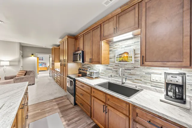 a living room with fireplace furniture and a wooden floor
