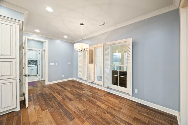 a kitchen with granite countertop a sink cabinets stainless steel appliances and a window