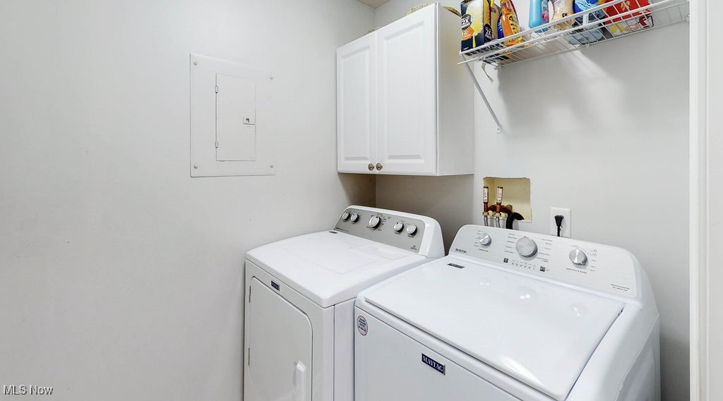1005 Canyon View Road, Unit F Northfield, OH 44067 - Photo 15 of 28 Laundry area with cabinets, electric panel, and washing machine and clothes dryer