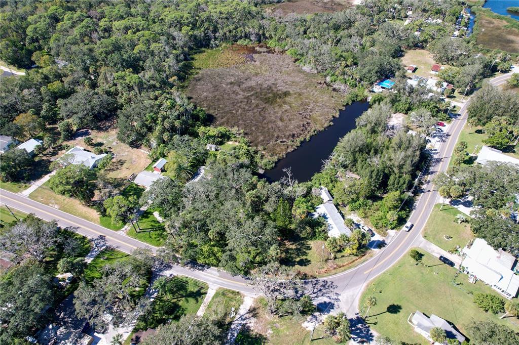 18905 Aripeka Road Aripeka, FL 34679 - Photo 18 of 43 an aerial view of residential house with outdoor space and trees all around