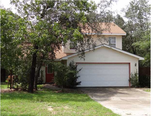 a front view of house with yard and trees