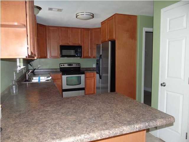 70 Cypress Lane Freeport, FL 32439 - Photo 2 of 21 a kitchen with stainless steel appliances granite countertop a refrigerator stove and microwave