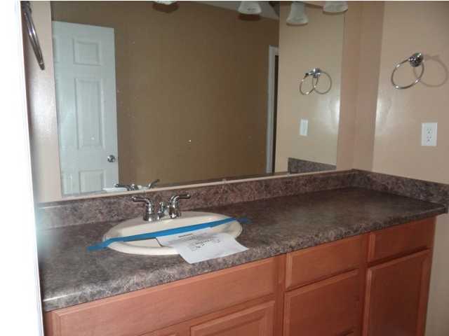 70 Cypress Lane Freeport, FL 32439 - Photo 12 of 21 a bathroom with a granite countertop sink and a mirror