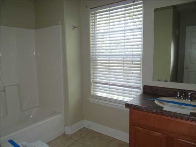 70 Cypress Lane Freeport, FL 32439 - Photo 18 of 21 a bathroom with a granite countertop sink and a bathtub