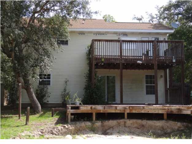 70 Cypress Lane Freeport, FL 32439 - Photo 20 of 21 a view of a house with a yard and wooden fence