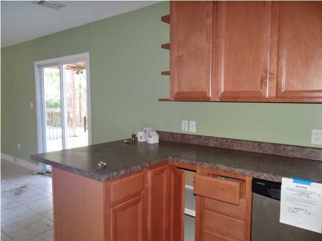 70 Cypress Lane Freeport, FL 32439 - Photo 4 of 21 a kitchen with granite countertop cabinets and sink