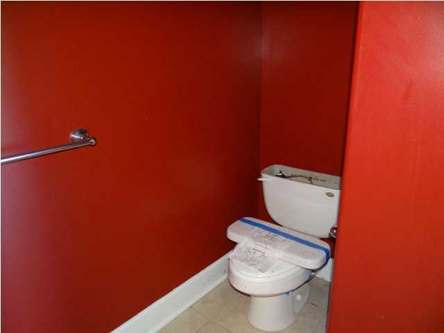 70 Cypress Lane Freeport, FL 32439 - Photo 9 of 21 a white toilet sitting next to a white wall