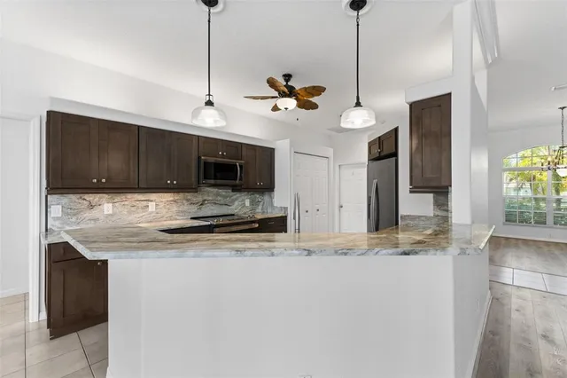 a kitchen with stainless steel appliances granite countertop a sink and stove