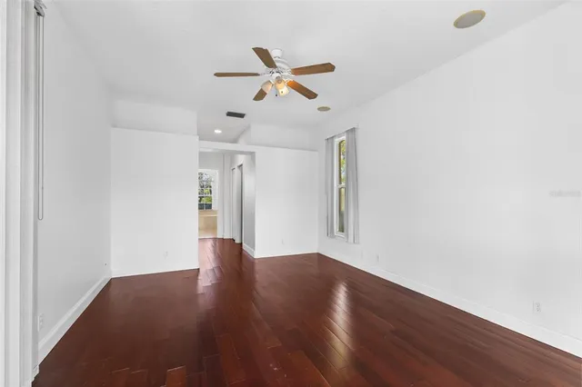 a bathroom with a granite countertop sink mirror bathtub and next to a window