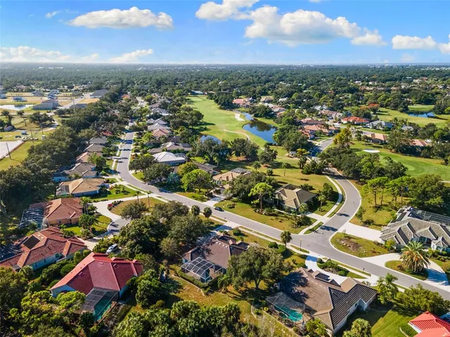 an aerial view of residential houses with outdoor space