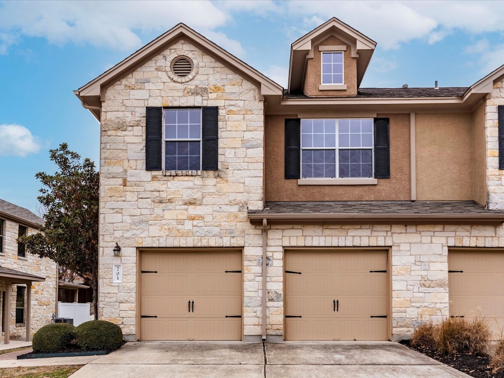 a front view of a house with garage