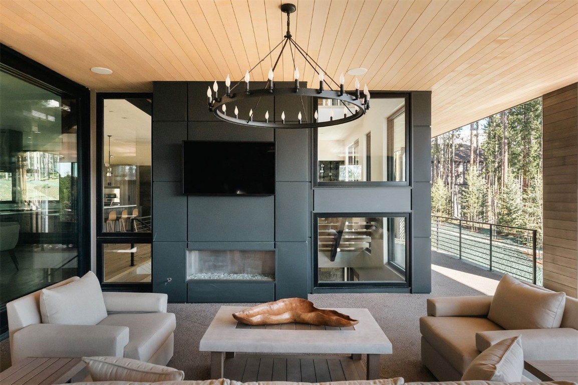 119 Boulder Circle Breckenridge, CO 80424 - Photo 15 of 50 a living room with furniture a fireplace and a floor to ceiling window