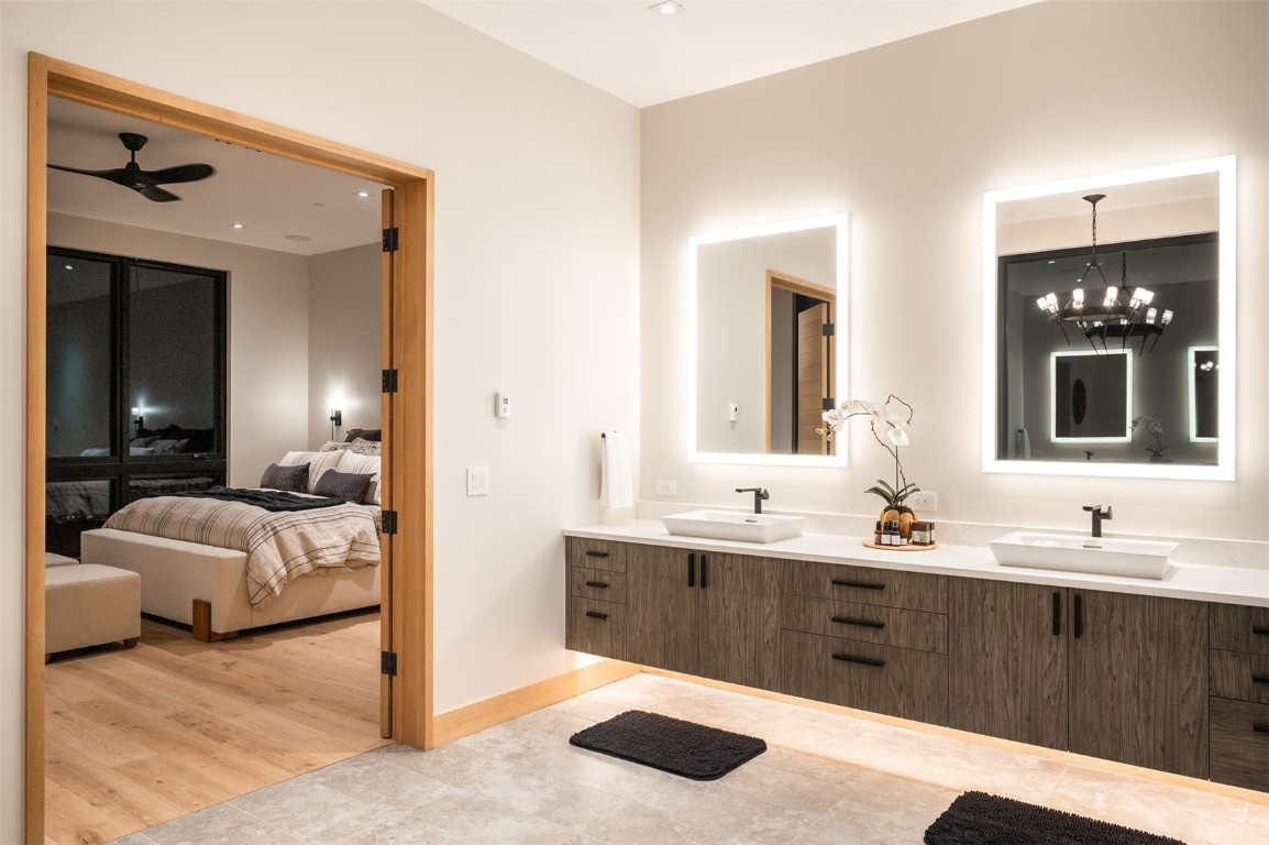 119 Boulder Circle Breckenridge, CO 80424 - Photo 21 of 50 a en suite bathroom with a granite countertop sink and a mirror