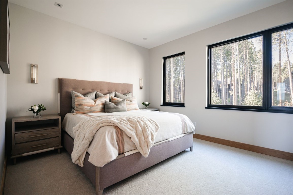 119 Boulder Circle Breckenridge, CO 80424 - Photo 29 of 50 a large bed sitting in a bedroom next to a window
