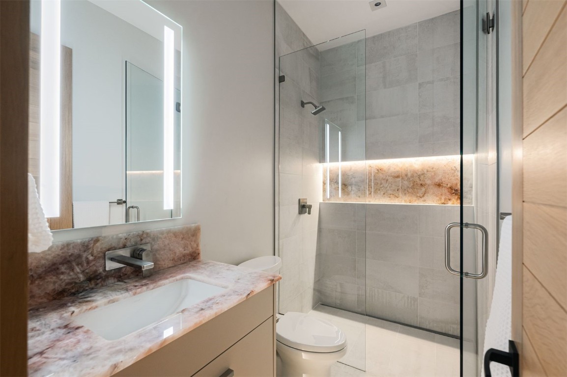 119 Boulder Circle Breckenridge, CO 80424 - Photo 30 of 50 a bathroom with a granite countertop sink toilet and shower