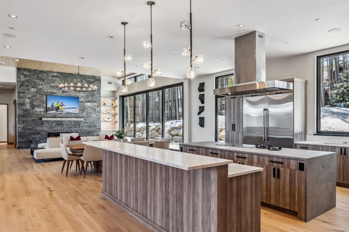119 Boulder Circle Breckenridge, CO 80424 - Photo 9 of 50 a open kitchen with stainless steel appliances granite countertop a stove top oven a dining table and chairs