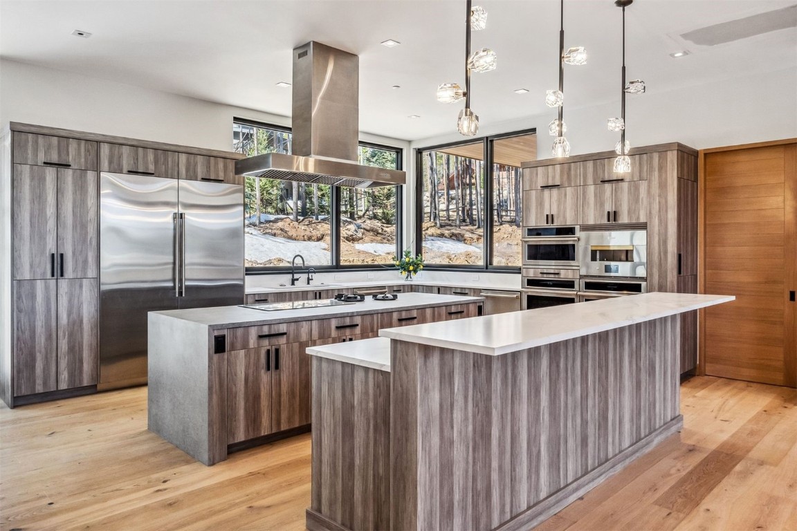119 Boulder Circle Breckenridge, CO 80424 - Photo 10 of 50 a kitchen with stainless steel appliances a sink a stove a refrigerator and chairs
