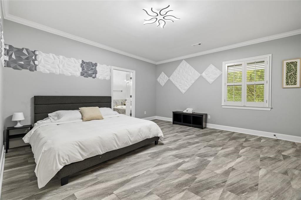 3687 Briarcliff Road Northeast Atlanta, GA 30345 - Photo 121 of 131 a bedroom with a large bed and a chandelier
